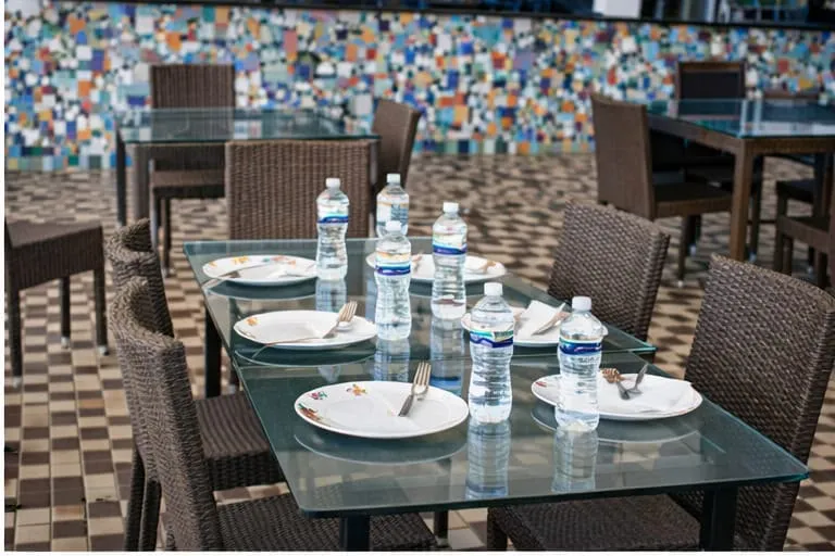 Table set with plates and water at Urban Rasoi