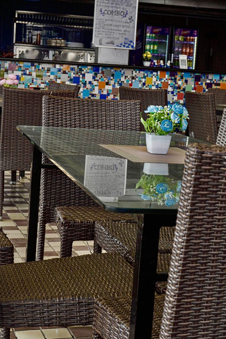 Table with fresh flowers and the combo menu at Urban Rasoi